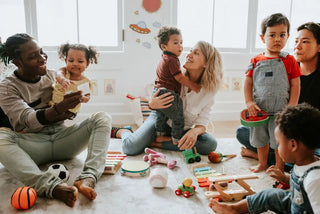 A playful gathering of adults and children enjoying snacks and toys together.