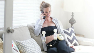 Person using a breast pump while talking on a phone.