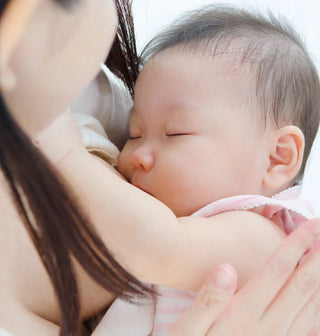 A sleeping baby nestled against someone’s shoulder.