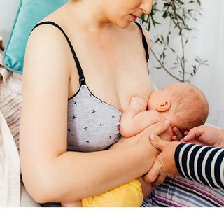 A nursing mother breastfeeding her newborn baby.